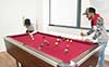 Students playing a game on the pool table